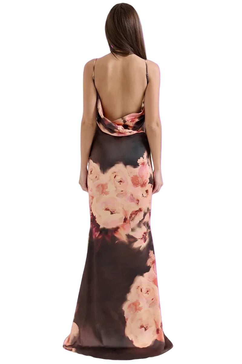 Woman wearing a floral dress with a pink background