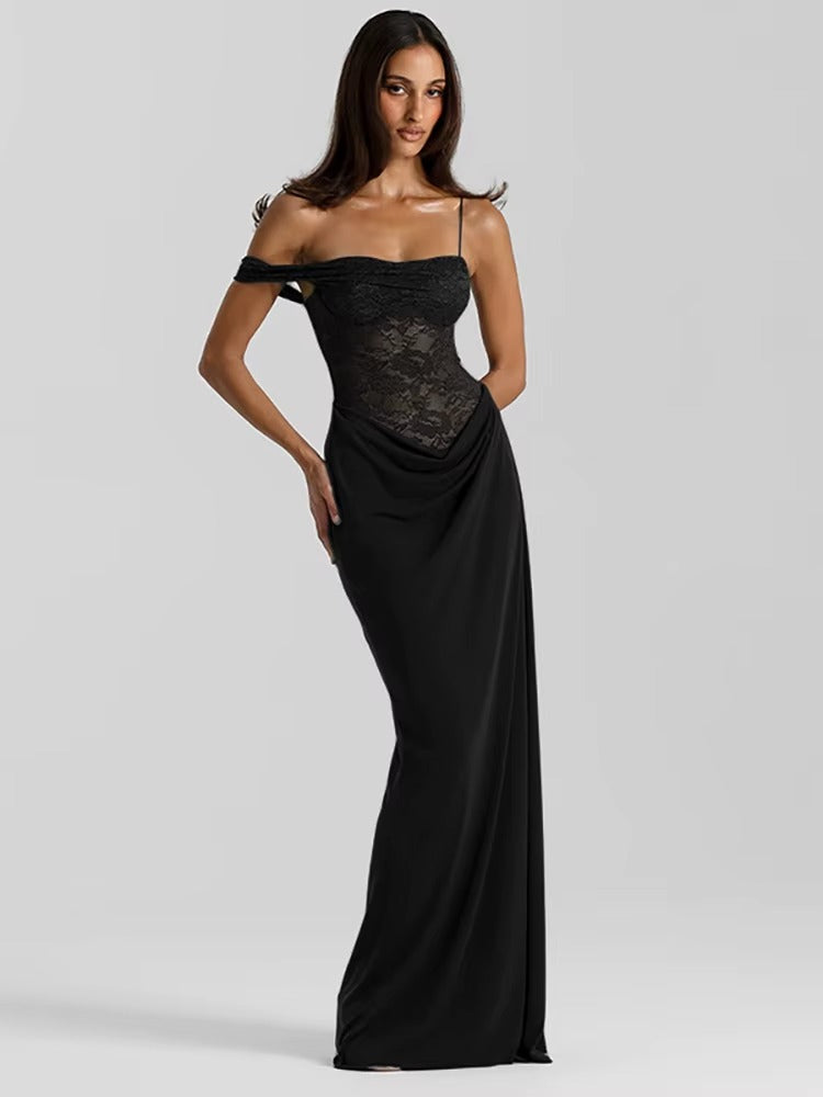 Woman wearing a black off-shoulder evening gown on a gray background